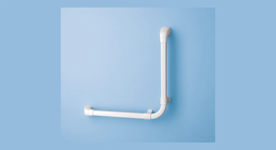 White Maxi-Grip grab rail with a 90-degree angle, mounted on a pale blue wall